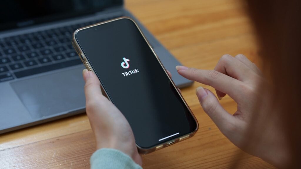TikTok app on smartphone for social media marketing and content creation.
