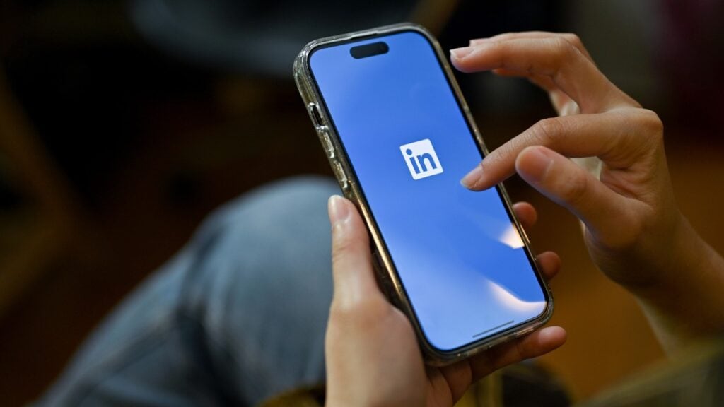 LinkedIn logo on smartphone screen, social media networking concept.